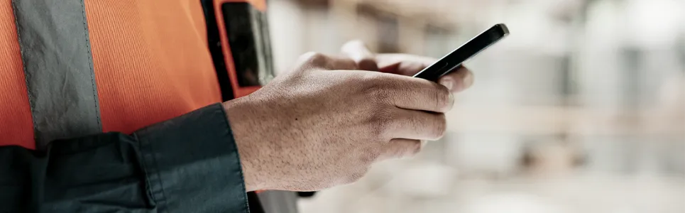 superintendent using an app on his phone to track construction workers time